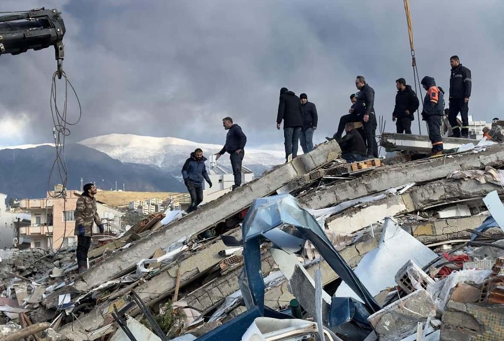 Emergency teams search for survivors in the rubble of a destroyed building, in Iskenderun, Turkey