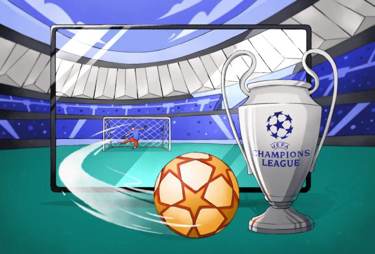 A UCL soccer ball in the foreground, with the UEFA Champions League trophy and a goalpost with a goalkeeper diving.