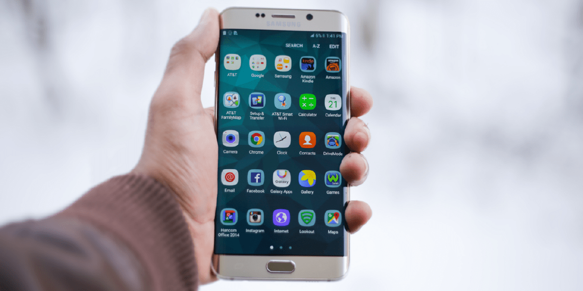 Person holding an unlocked Android phone Person holding an unlocked Android phone