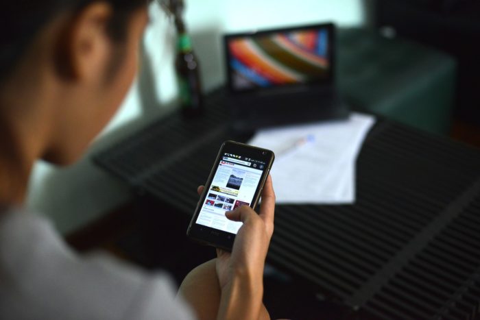 Woman reading news on smartphone