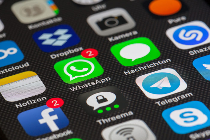 Facebook and WhatsApp icons on a smartphone
