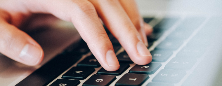 hand on a laptop hand on a laptop