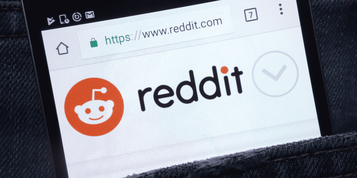 Mobile phone screen displaying the Reddit logo Mobile phone screen displaying the Reddit logo