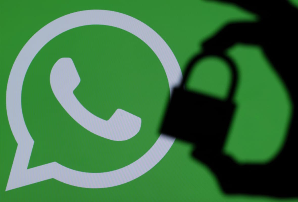 Padlock Held Up Against a WhatsApp Logo Padlock Held Up Against a WhatsApp Logo