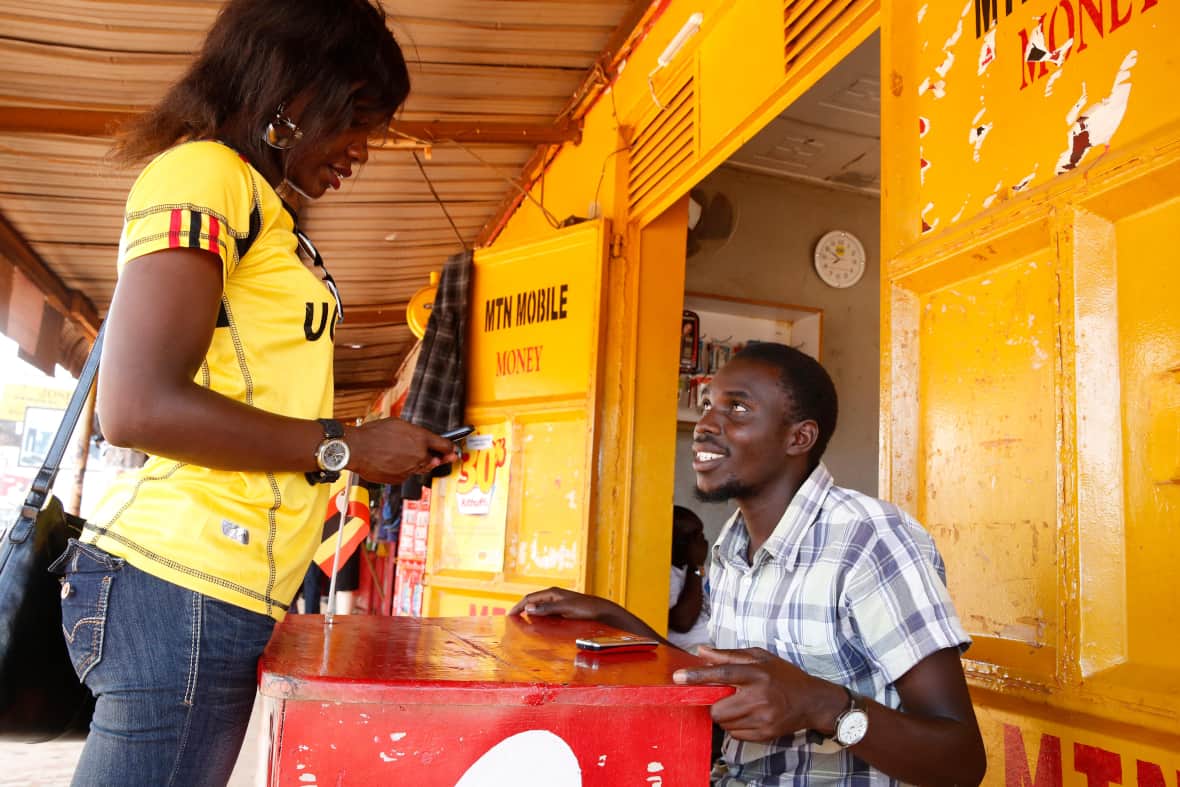 Ugandan woman sending money by cell phone