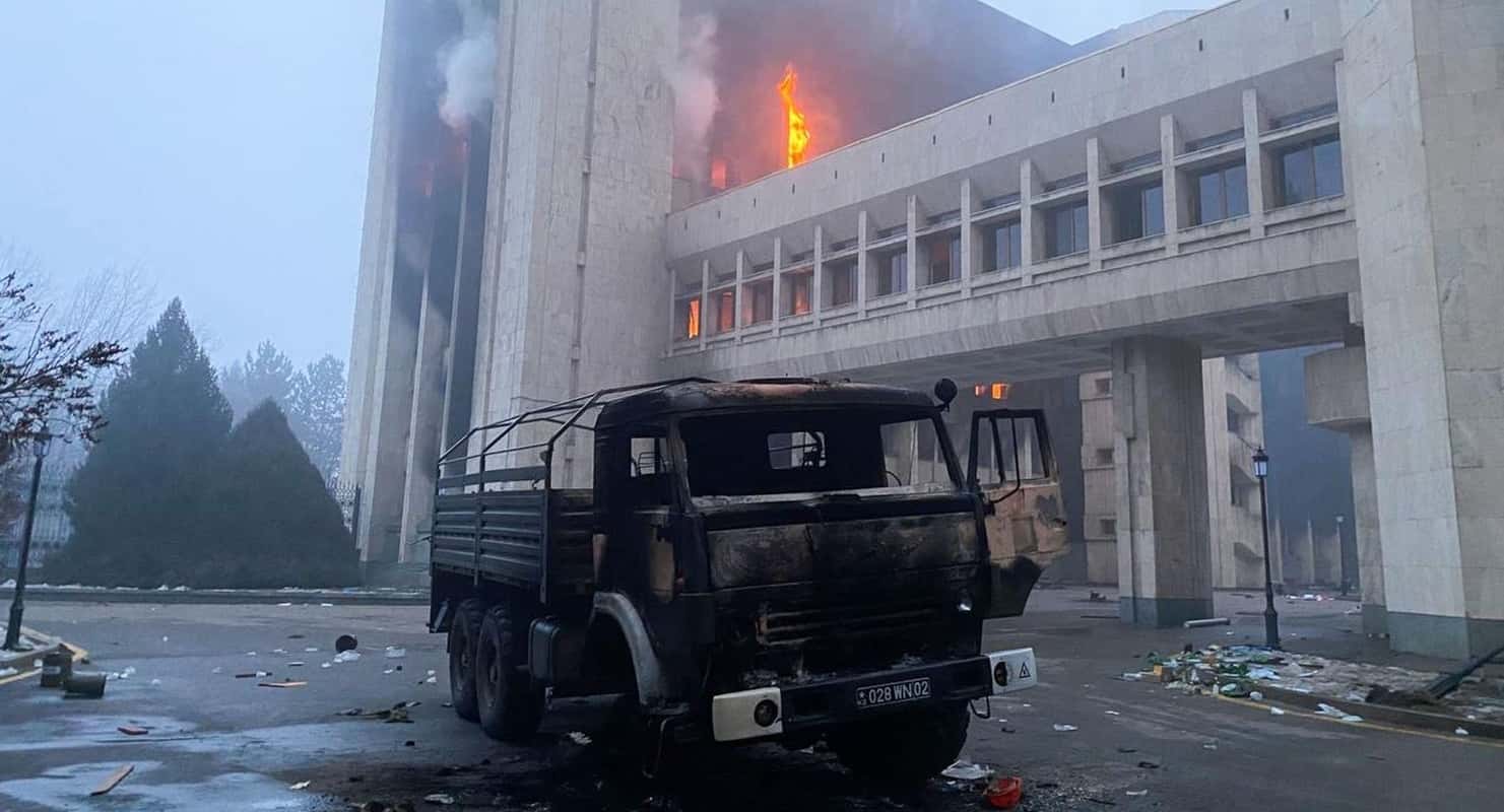 Cost of Internet Shutdowns 2022 tracker hero image showing burning public building during Kazakhstan protests