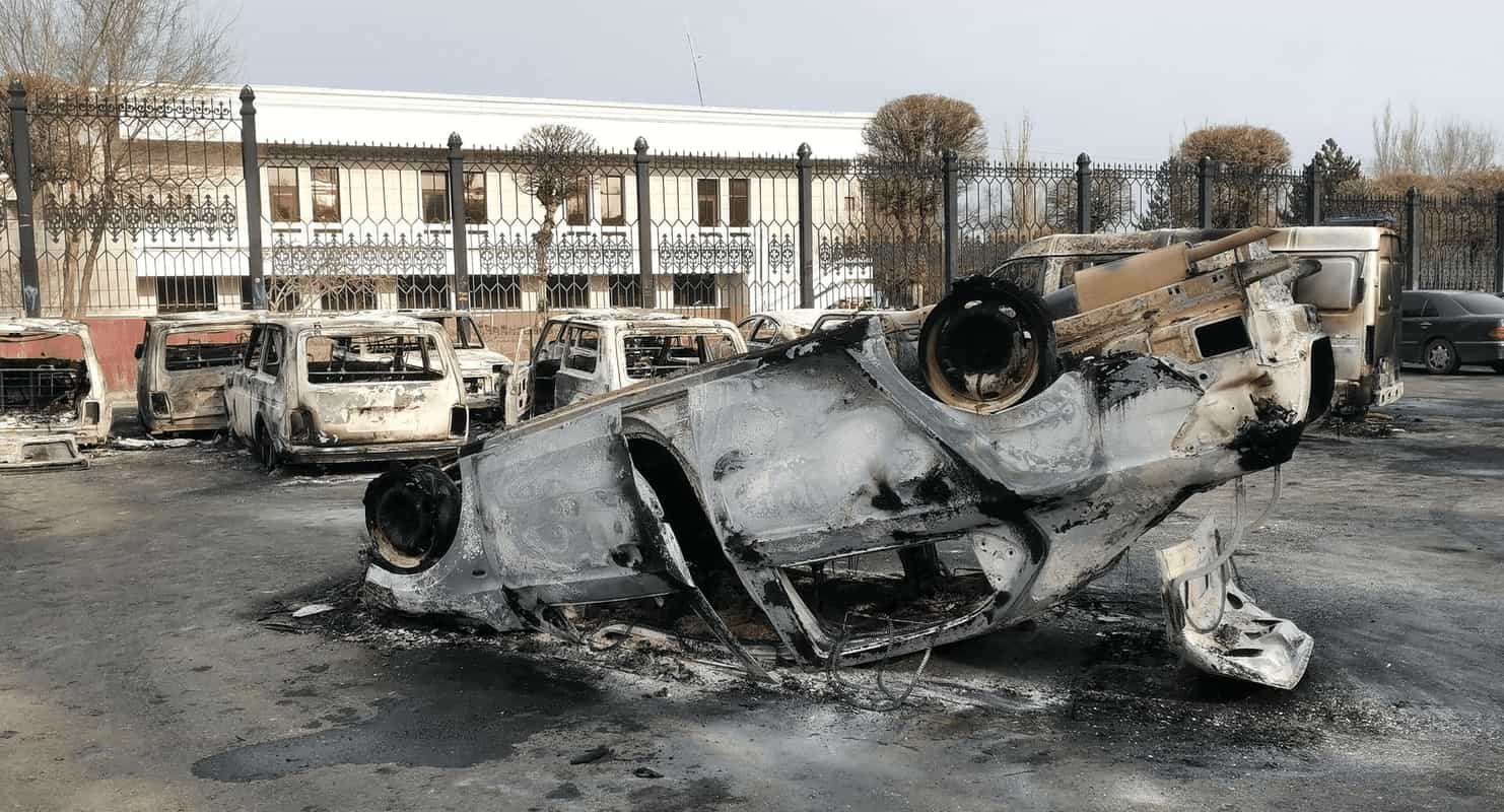 Internet shutdown VPN tracker header image showing burnt out cars after protests in Kazakhstan