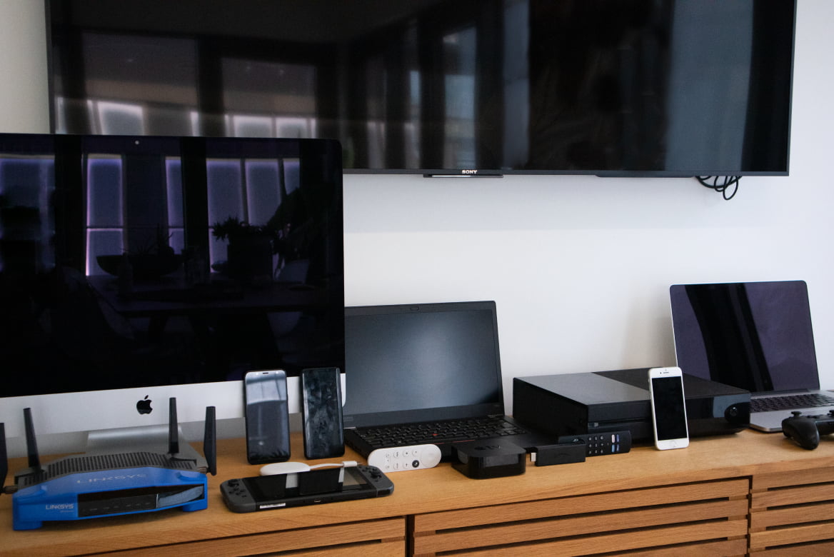 A series of tech products lined up, including computers and streaming devices