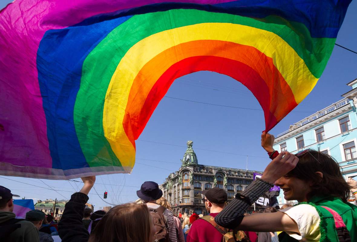 Marchers with a rainbow flag in St Petersburg, Russia.