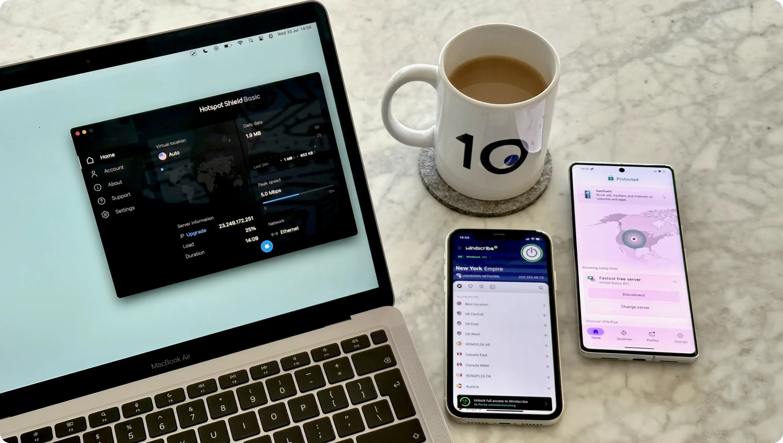 The best free VPN services header image showing ProtonVPN on an Android phone, Windscribe on an iPhone and Hotspot Shield Basic on a Macbook Air